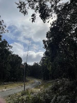 Squidpole attached to roadsign for antenna support